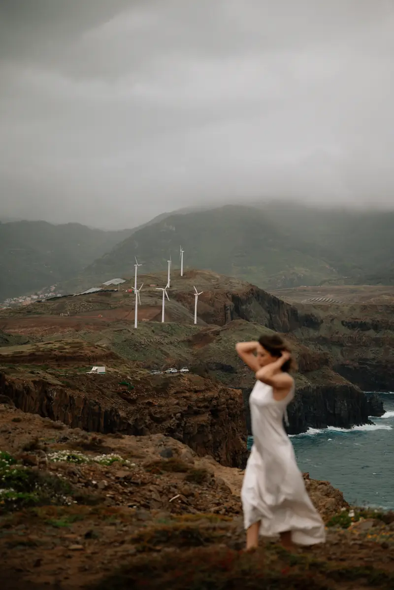 A woman in a white dress on the cliffs of São Lourenço